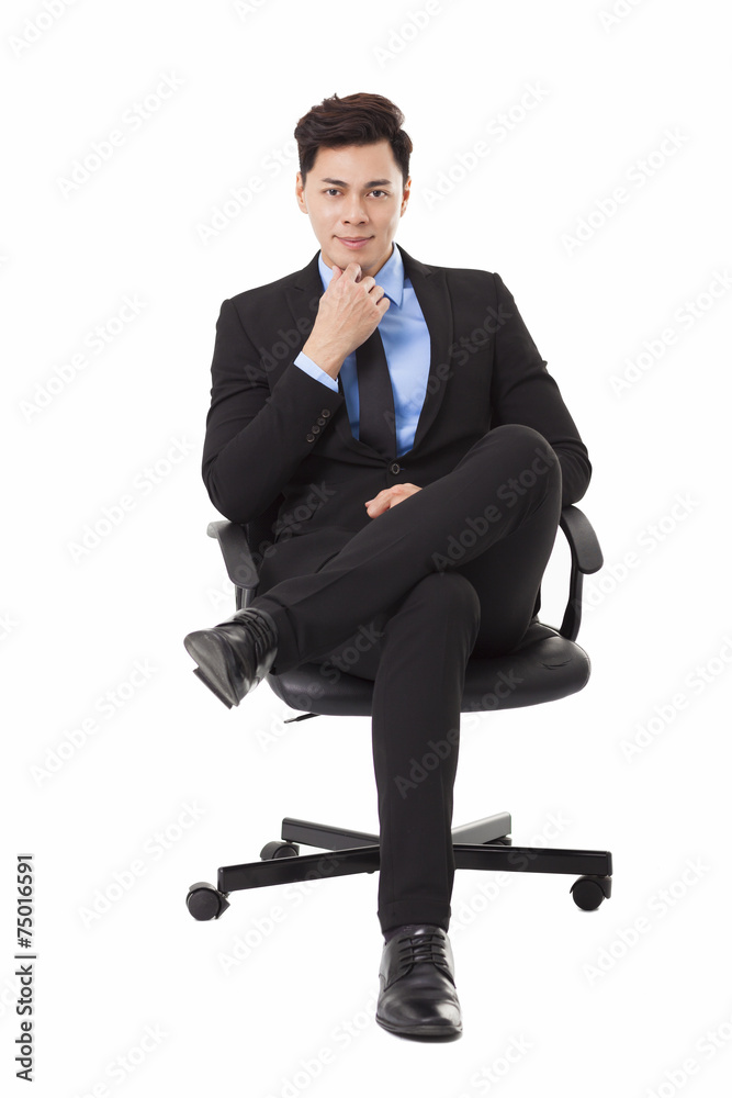 Young businessman sitting in a chair and thinking Young businessman sitting in a chair and thinking