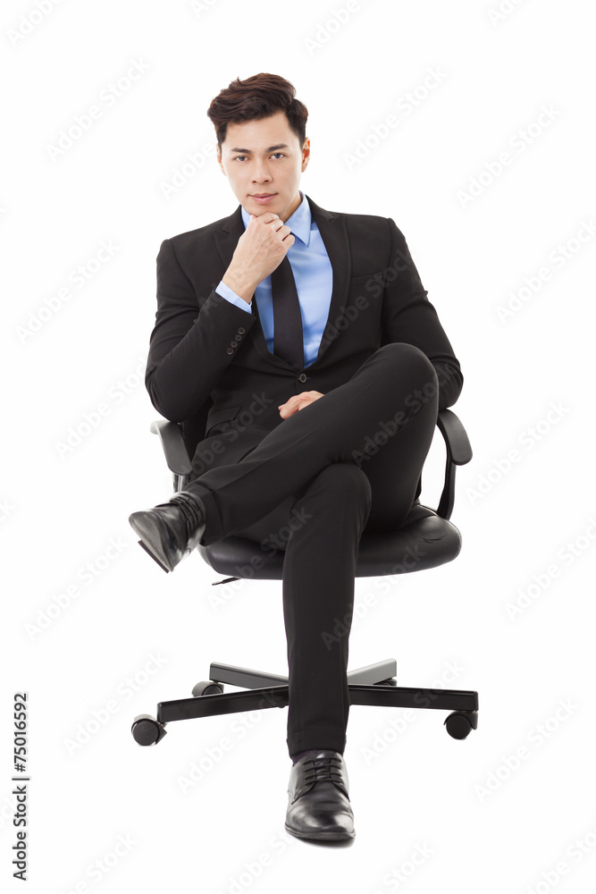 Young businessman sitting in a chair and thinking Young businessman sitting in a chair and thinking