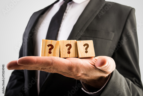 Canvas Print Three wooden cubes displaying question marks