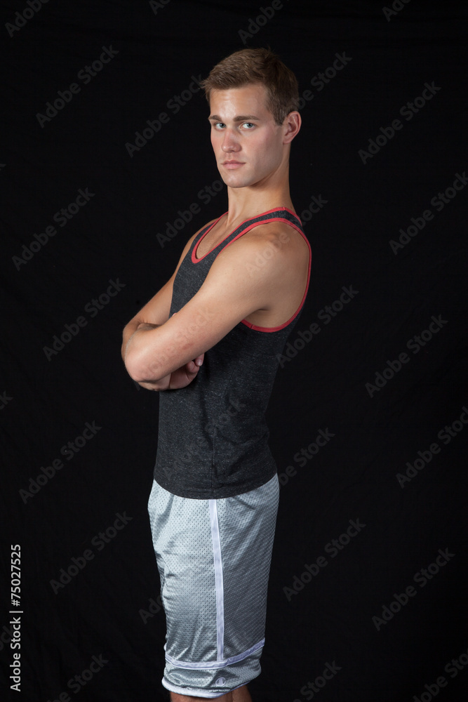 man in exercise outfit, standing with arms crossed man in exercise outfit, standing with arms crossed