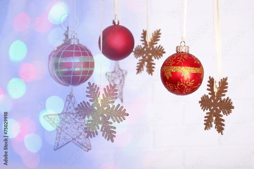 Christmas decorations hanging on festive background Christmas decorations hanging on festive background