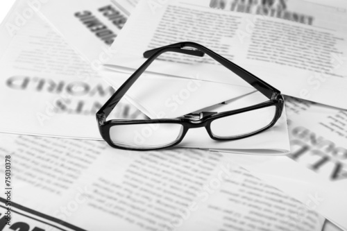 Glasses and newspapers  close-up