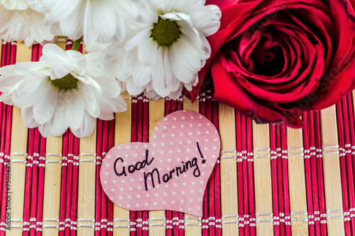 paper heart on the background of a bouquet of flowers