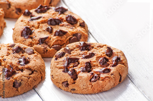 Chocolate cookies close up on white wood background