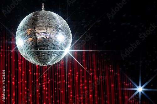 Disco ball with stars in nightclub lit by spotlight