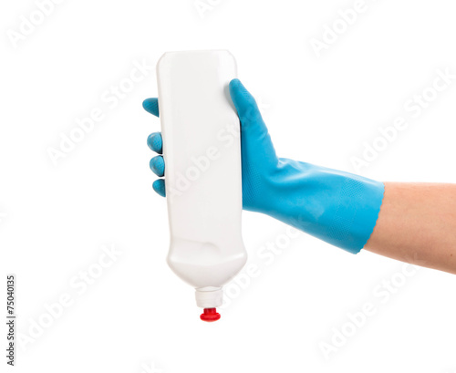 Hand in gloves holds bottle.