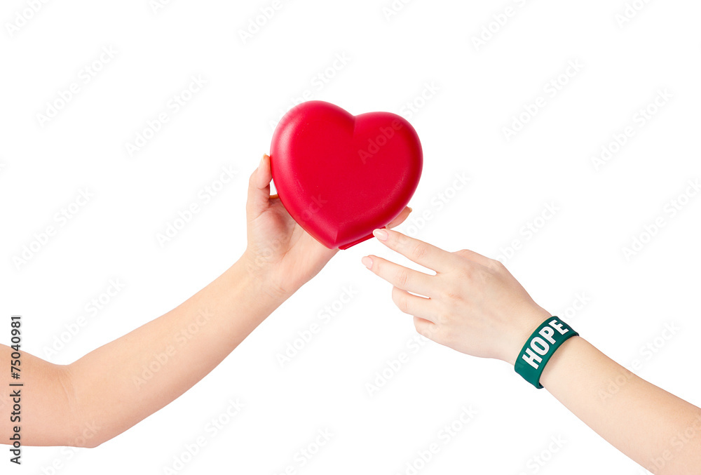 Hand giving hope to heart in hand isolated on white background Hand giving hope to heart in hand isolated on white background