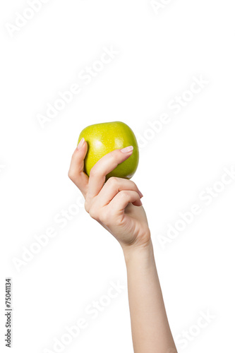 Woman's hand holding and showing a  green apple