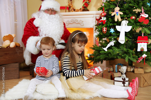 Santa Claus with two little...