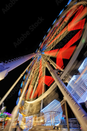 Fairground ferris wheel with colorful light trails