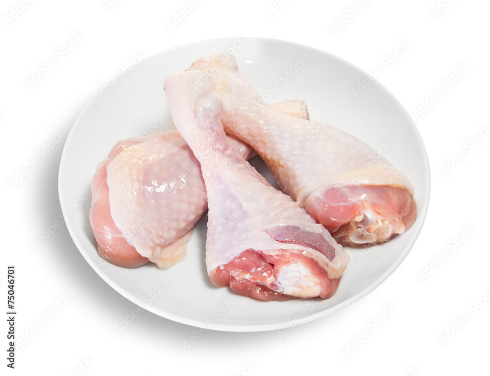 Three Raw Chicken Legs On White Plate Three Raw Chicken Legs On White Plate