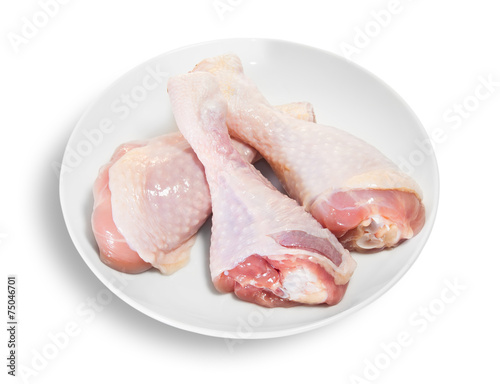 Three Raw Chicken Legs On White Plate