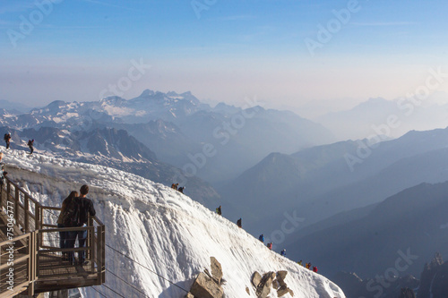 Mont Blanc mountaneers walking on snowy ridge. 