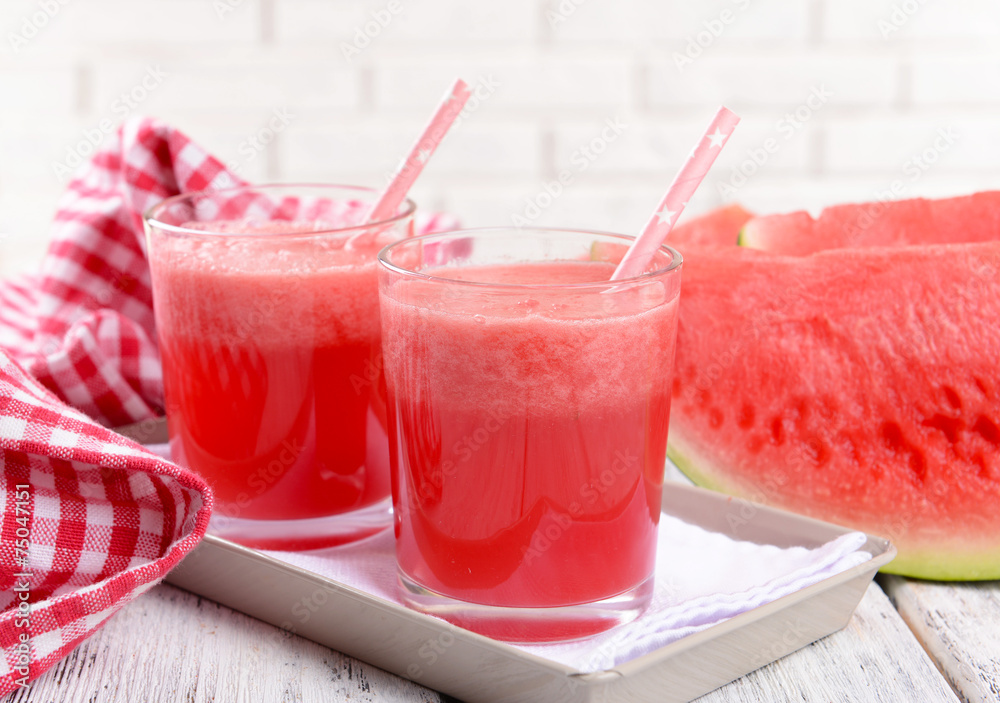 Juicy watermelon on table on brick wall background