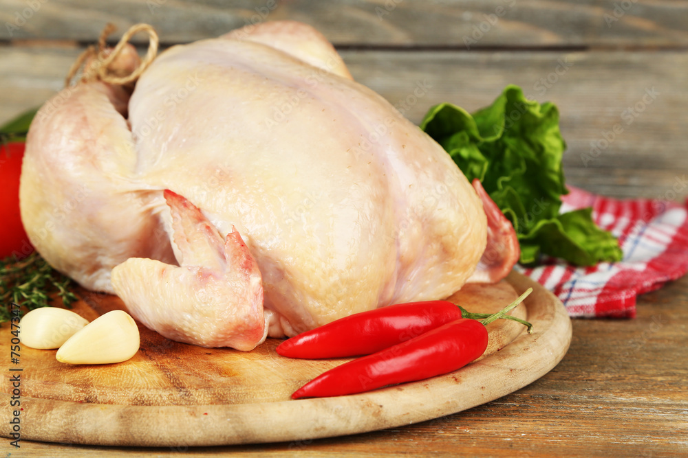 Raw chicken on wooden table Raw chicken on wooden table