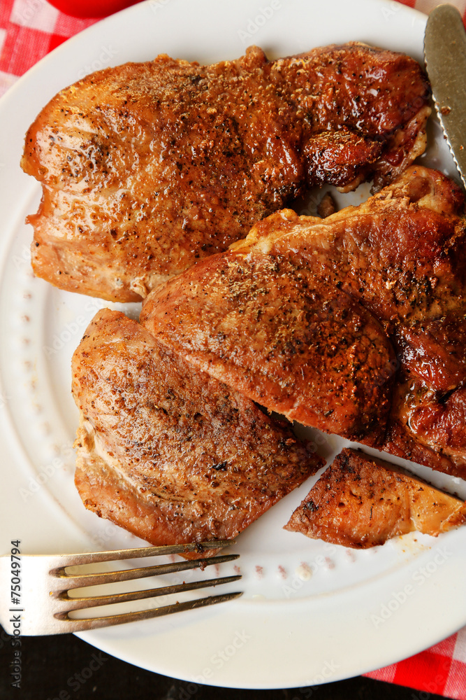 Roasted meat on plate, on wooden table background Roasted meat on plate, on wooden table background