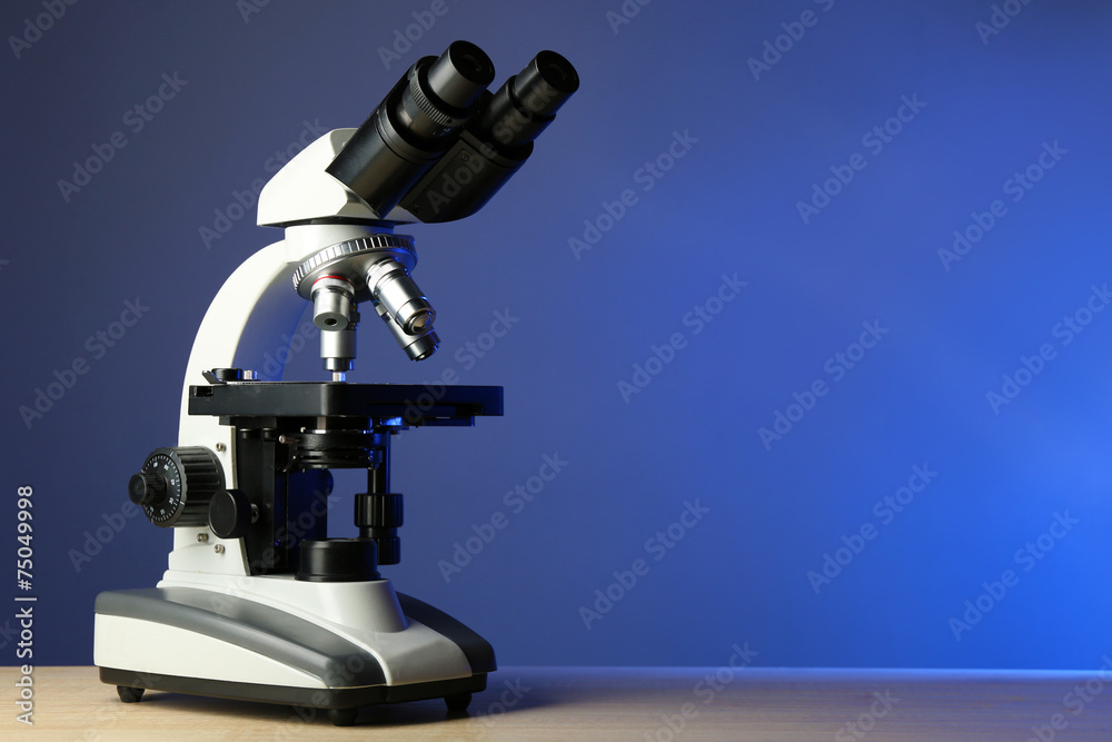 Microscope on table, on color background Microscope on table, on color background