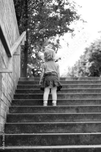 Portrait of a child on the steps of black-and-white © snesivan