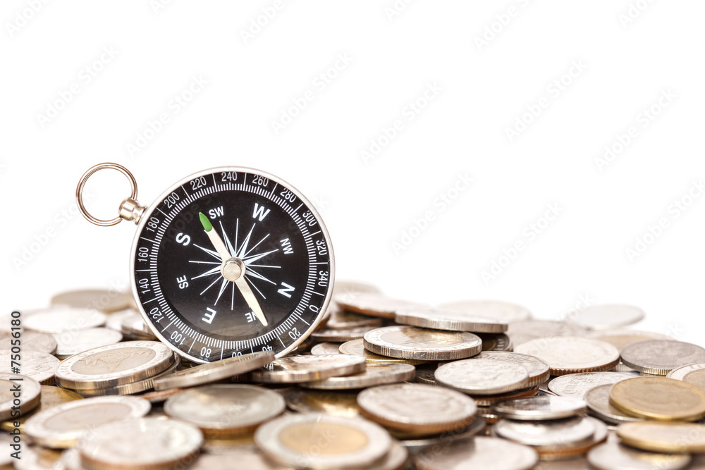 Close up Compass on coin stack Close up Compass on coin stack