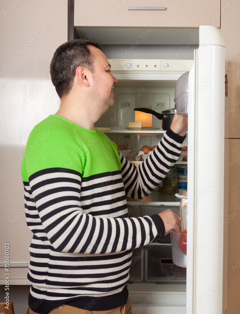 guy near refrigerator at home guy near refrigerator at home