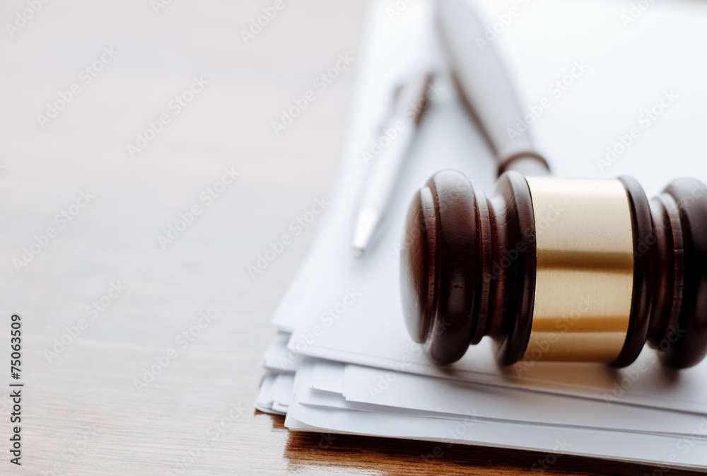 Gavel, ball pen and paper for notes on desktop Gavel, ball pen and paper for notes on desktop