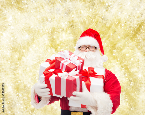 man in costume of santa claus with gift boxes