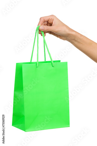 Woman's hand and green shopping bag