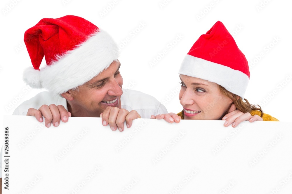 Festive couple showing a poster Festive couple showing a poster