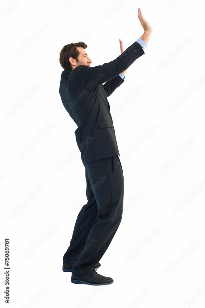 Focused businessman pushing with hands Focused businessman pushing with hands