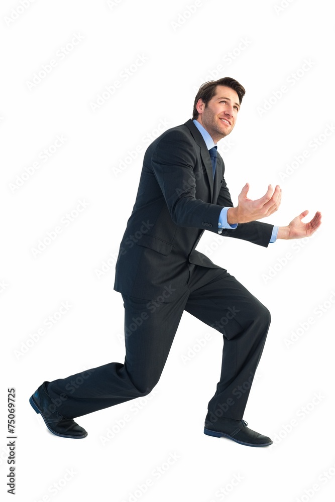 Businessman carrying something heavy with his hands Businessman carrying something heavy with his hands