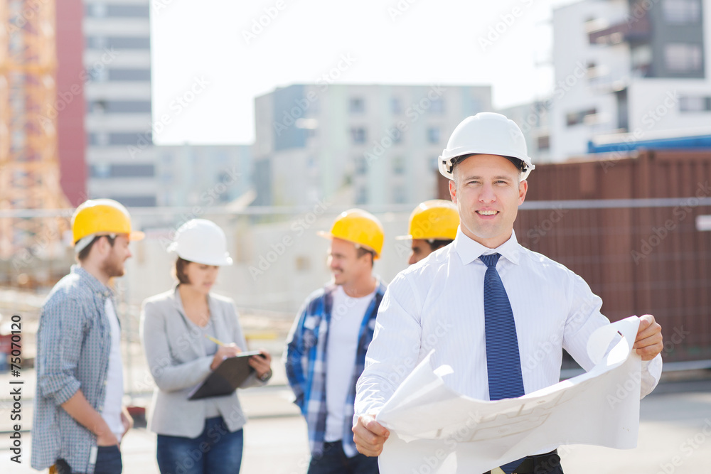 group of builders with tablet pc and blueprint group of builders with tablet pc and blueprint