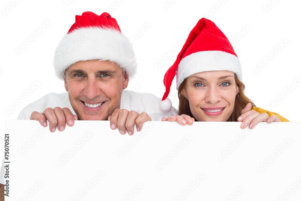 Festive couple showing a poster Festive couple showing a poster
