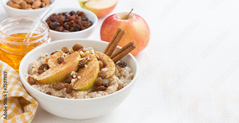 oatmeal with apples, raisins, cinnamon and ingredients on white