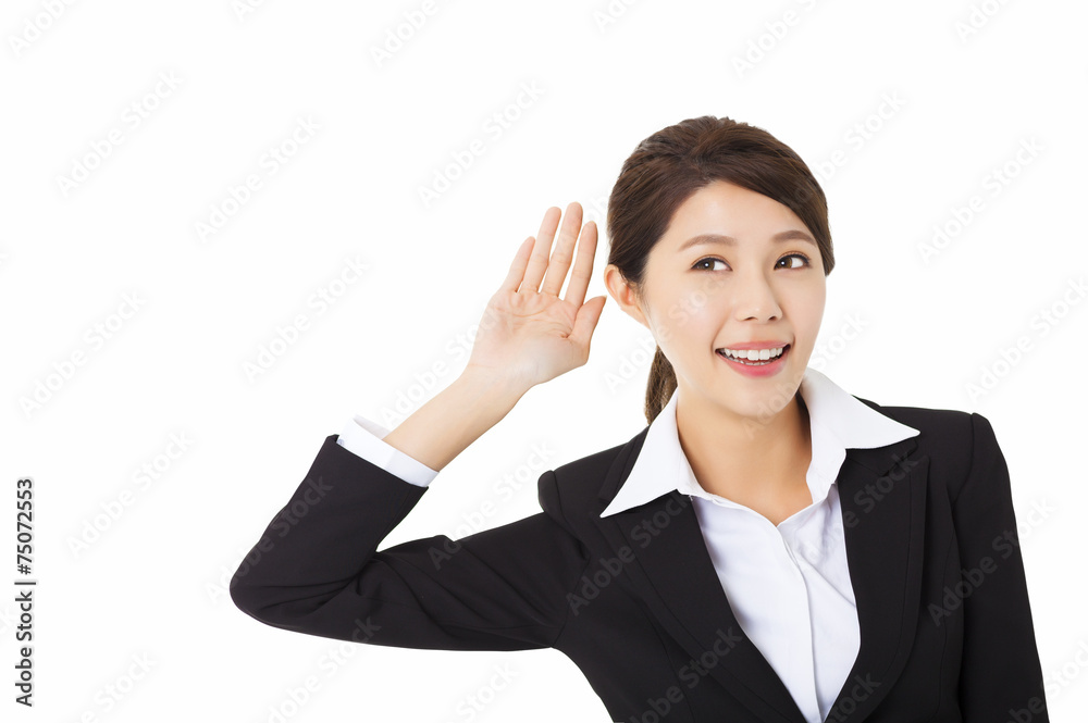 Young business woman putting hand to ear and listening Young business woman putting hand to ear and listening