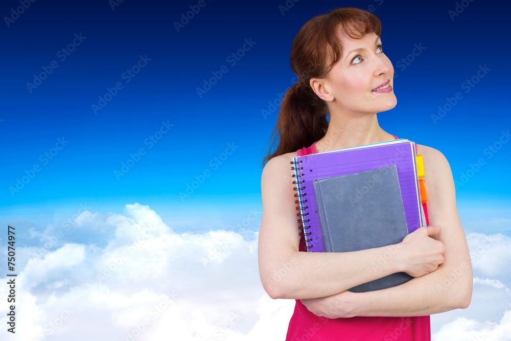 Composite image of woman holding her school notebooks Composite image of woman holding her school notebooks