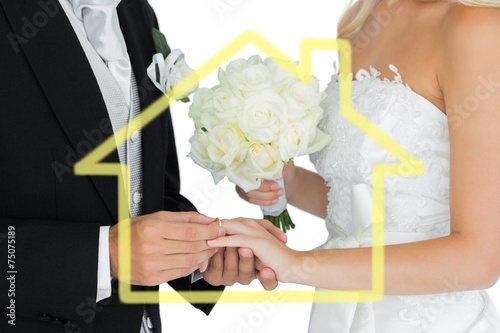 Young bridegroom putting on the wedding ring