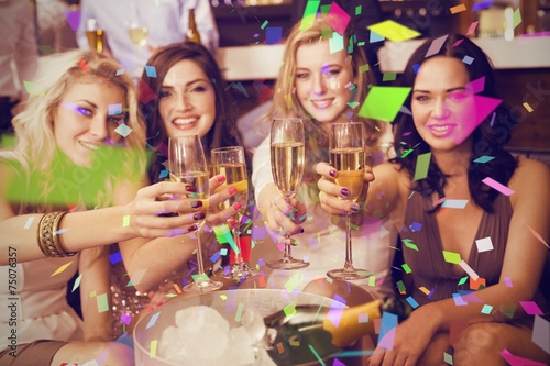 Composite image of pretty friends drinking champagne together