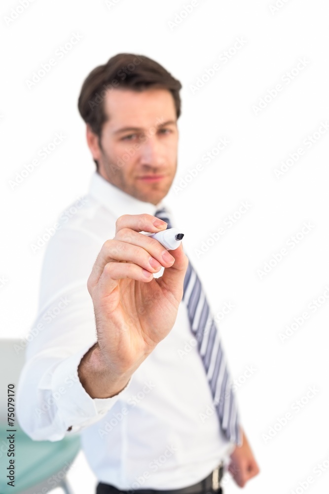 Focused businessman writing with marker Focused businessman writing with marker