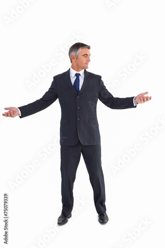 Businessman in suit spreading his arms