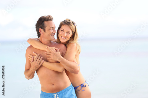 Cheerful 40-year-old couple at the beach