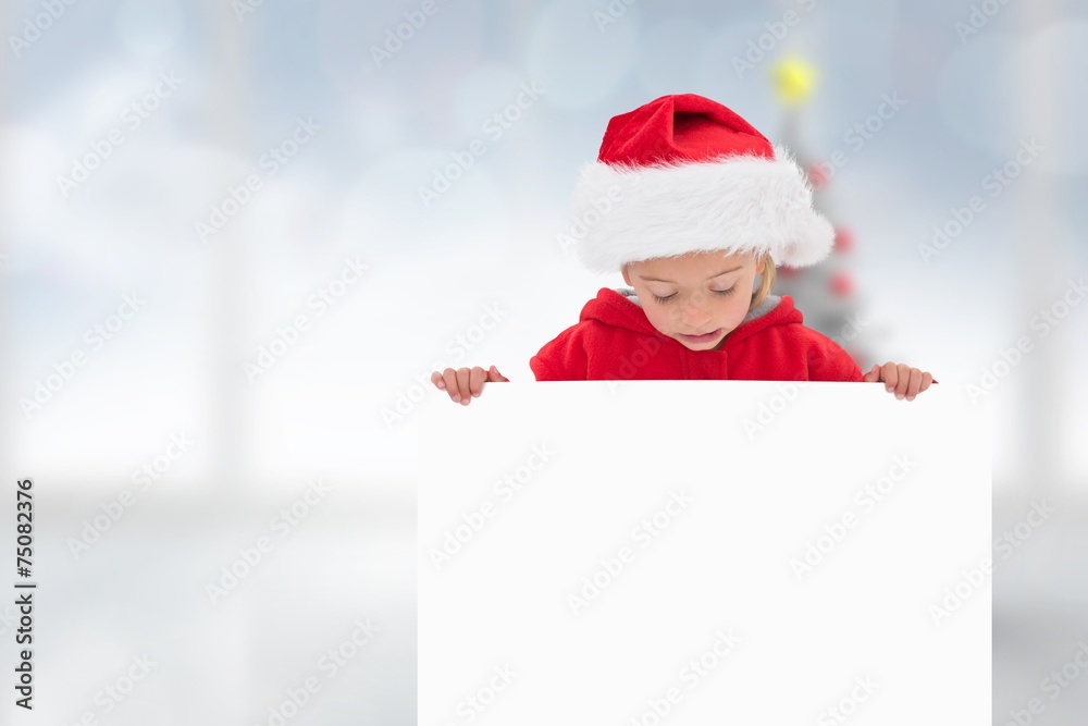 Composite image of festive little girl showing poster Composite image of festive little girl showing poster