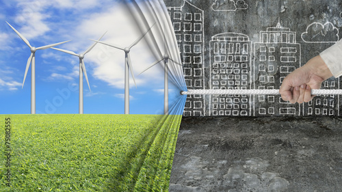 hand pulling open wind turbines curtain covering gray cityscape