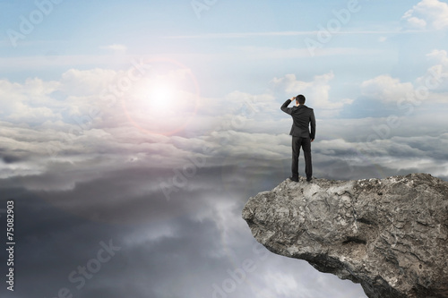 Obraz na plátně businessman looking on cliff with natural sky daylight cloudscap