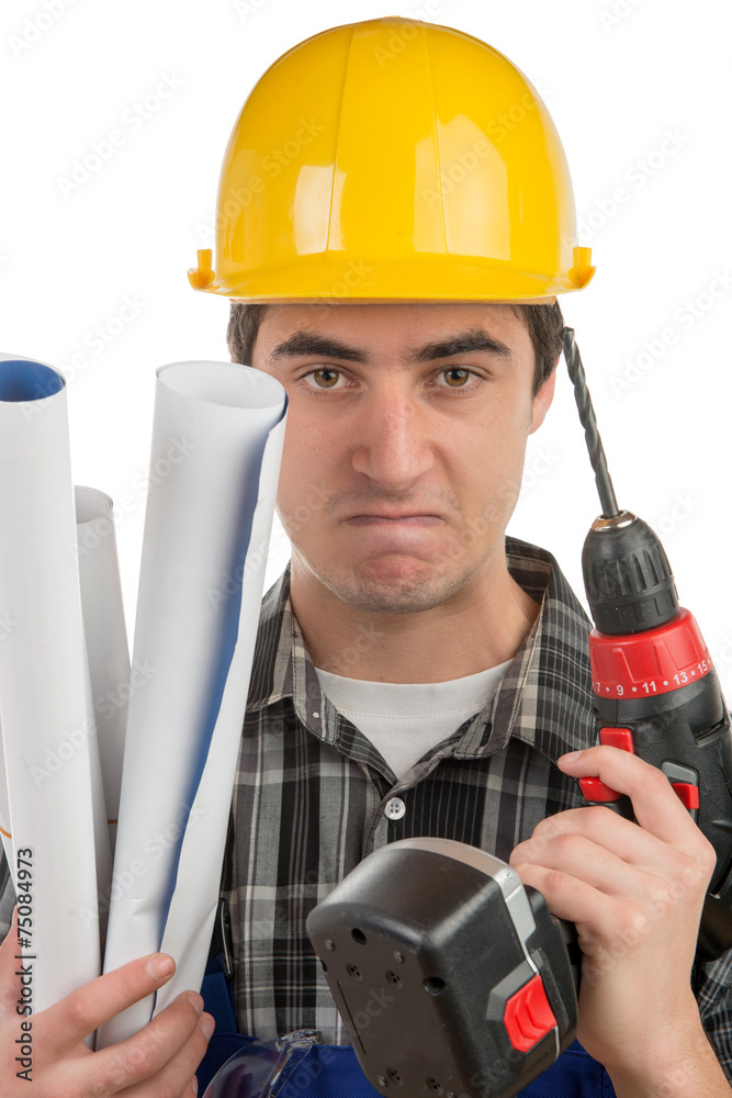 young worker with a drill is angry