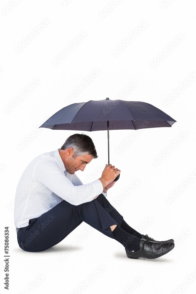 Businessman sitting and sheltering with umbrella Businessman sitting and sheltering with umbrella