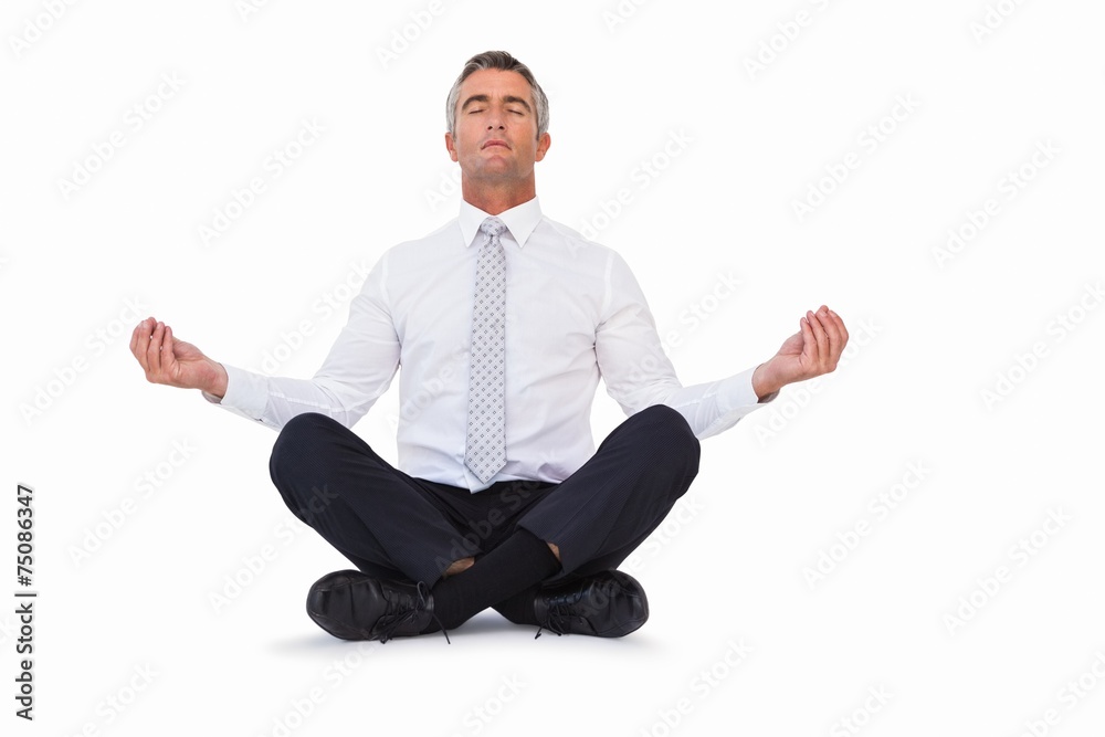 Peaceful businessman sitting in lotus pose Peaceful businessman sitting in lotus pose