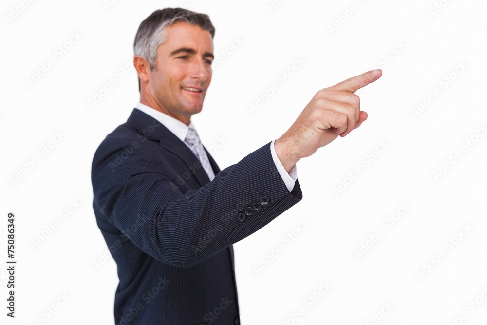 Smiling businessman in suit pointing Smiling businessman in suit pointing