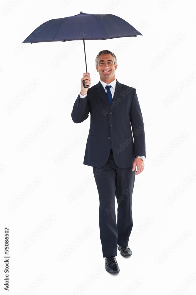 Happy businessman sheltering with umbrella Happy businessman sheltering with umbrella