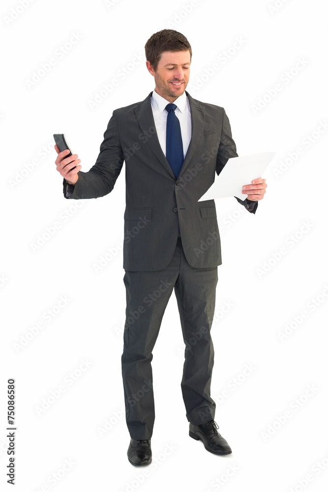 Businessman sending text holding page Businessman sending text holding page