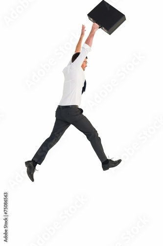 Businessman leaping with his briefcase
